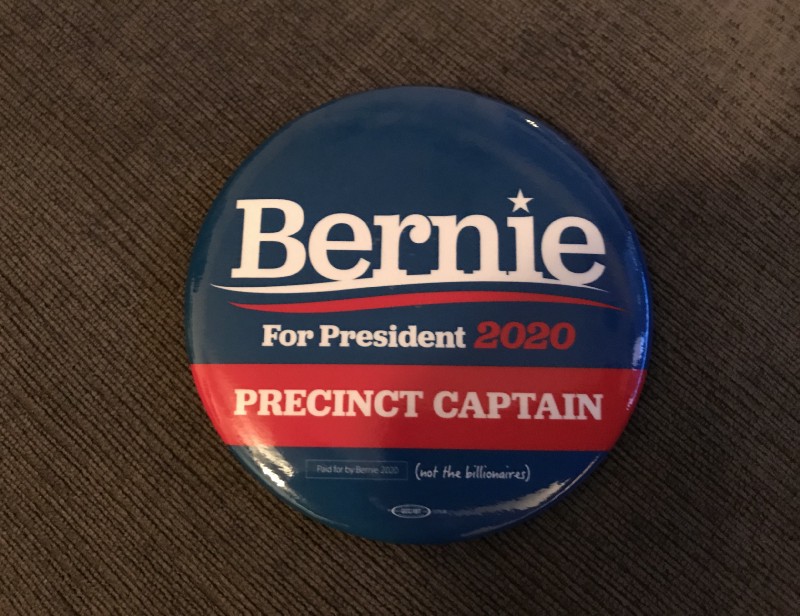 Photo of political campaign button that reads: “Bernie For President 2020 Precinct Captain” taken by author (Joyce O’Day).