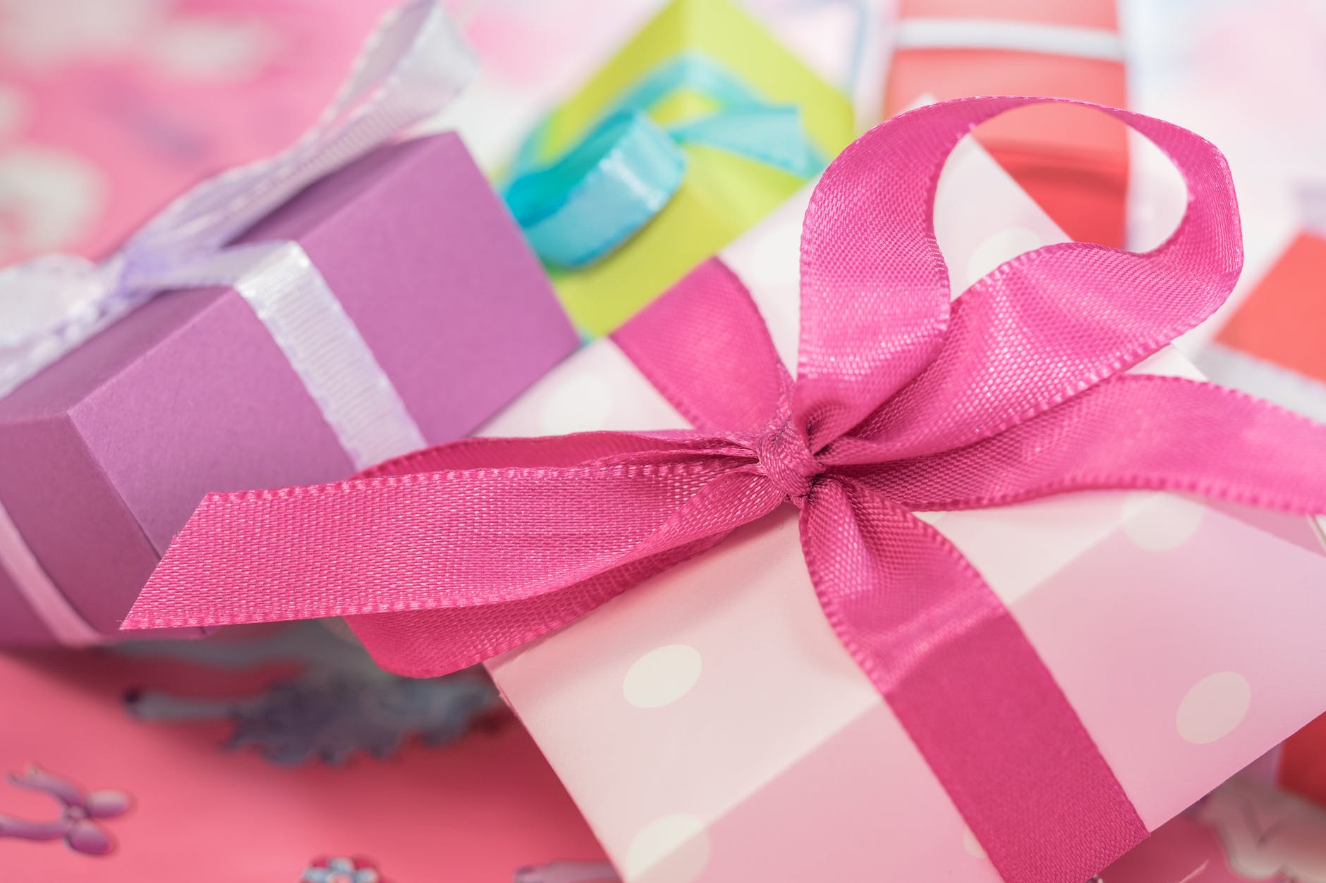 Photo of presents wrapped on pastel paper with bows.